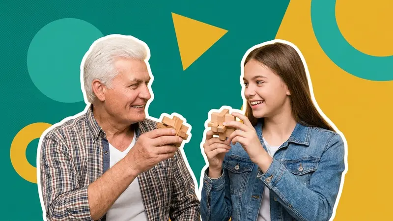 A grandfather and granddaughter each holding a wooden puzzle