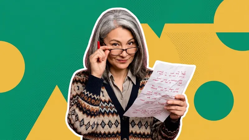 A teacher with a red pen looking over her glasses