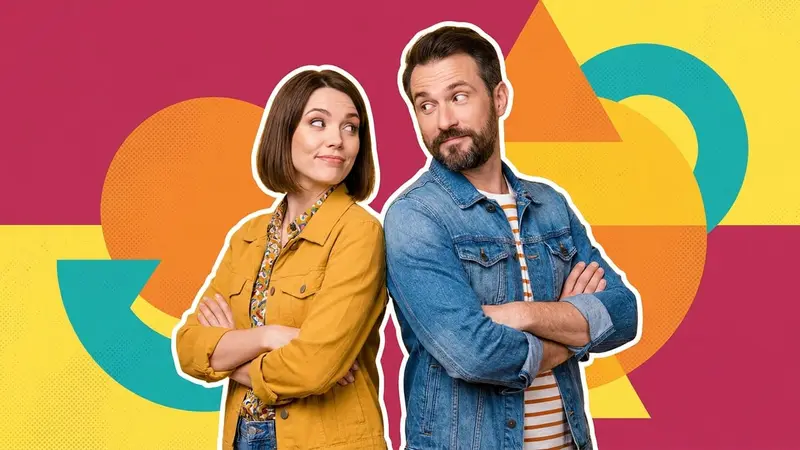 A couple standing back to back with their arms crossed